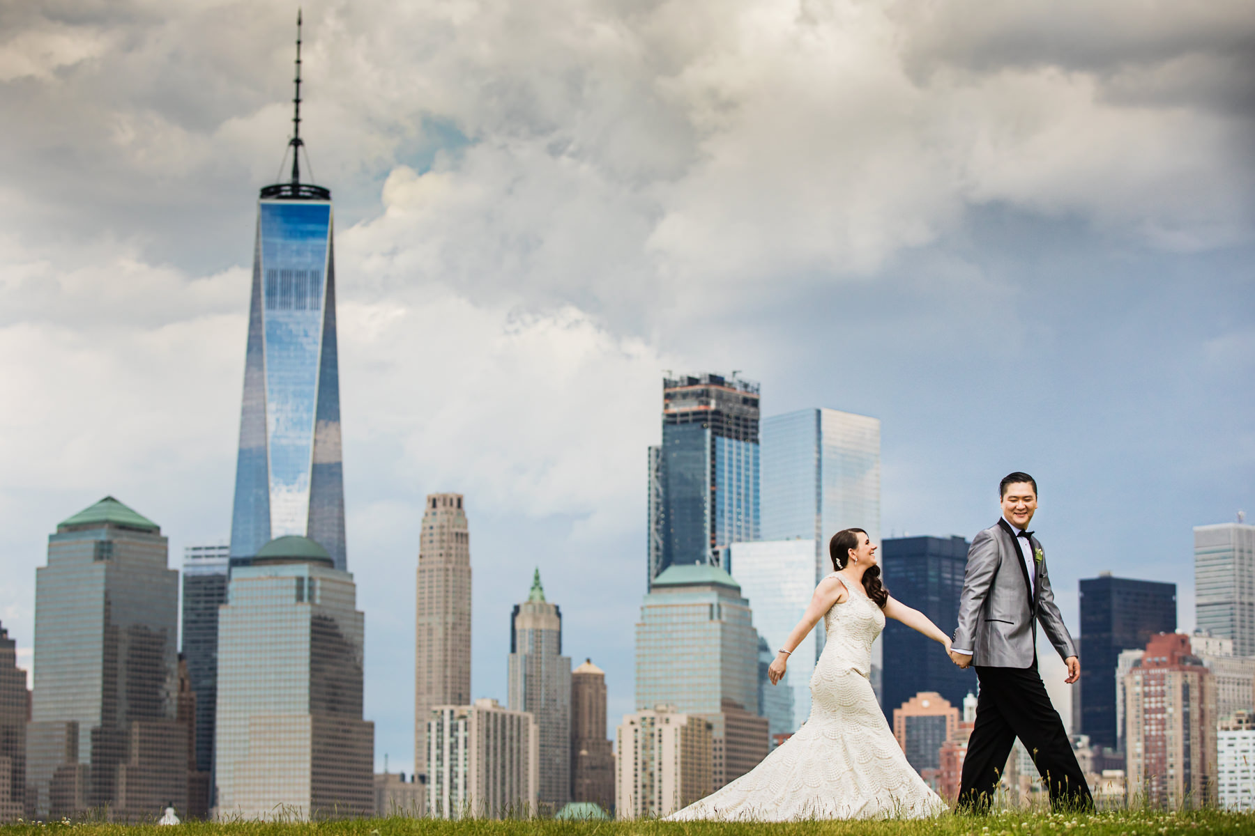 Bride and groom with NYC skyline, as taken from Liberty State Park in Jersey City