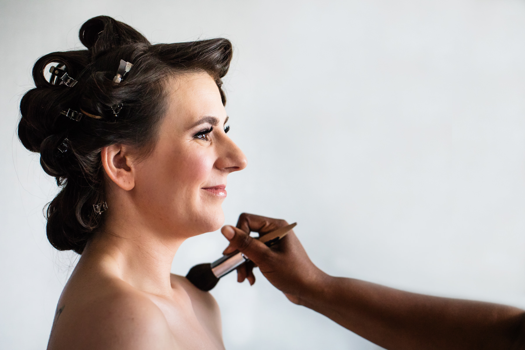 Bride getting gussied up on wedding day