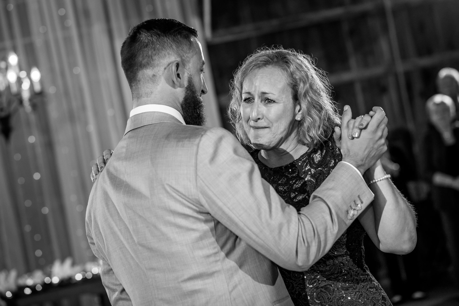 Emotional mother of groom dances with her son, rustic farm wedding in Stockton, NJ