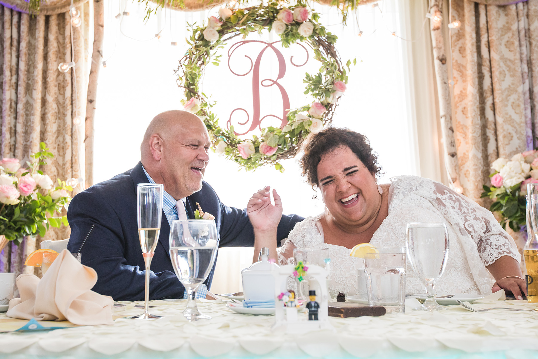 Bride and groom enjoy a laugh at their wedding reception at the Grand Hotel of Cape May