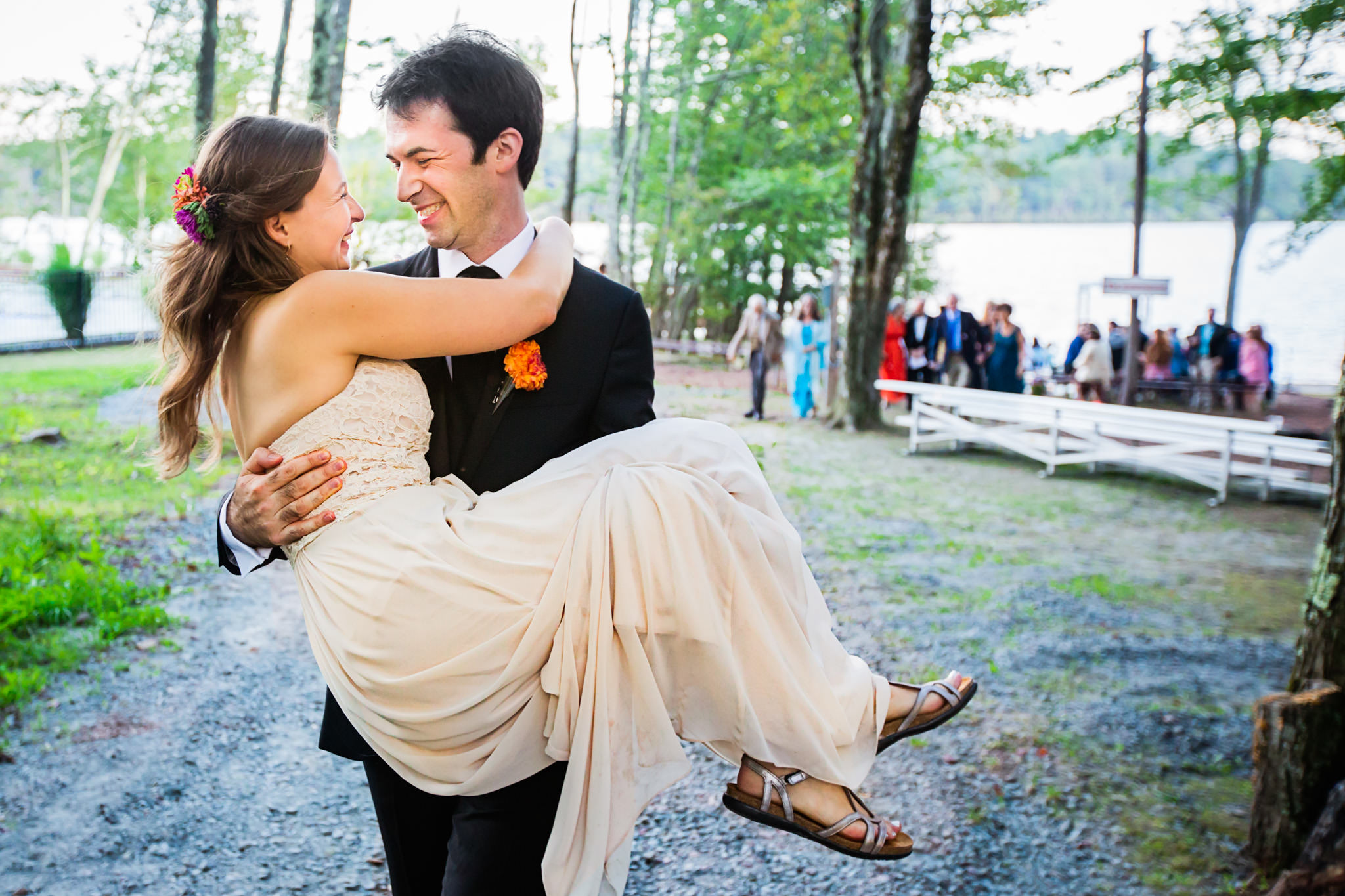 Groom carries bride at Camp Chipinaw wedding