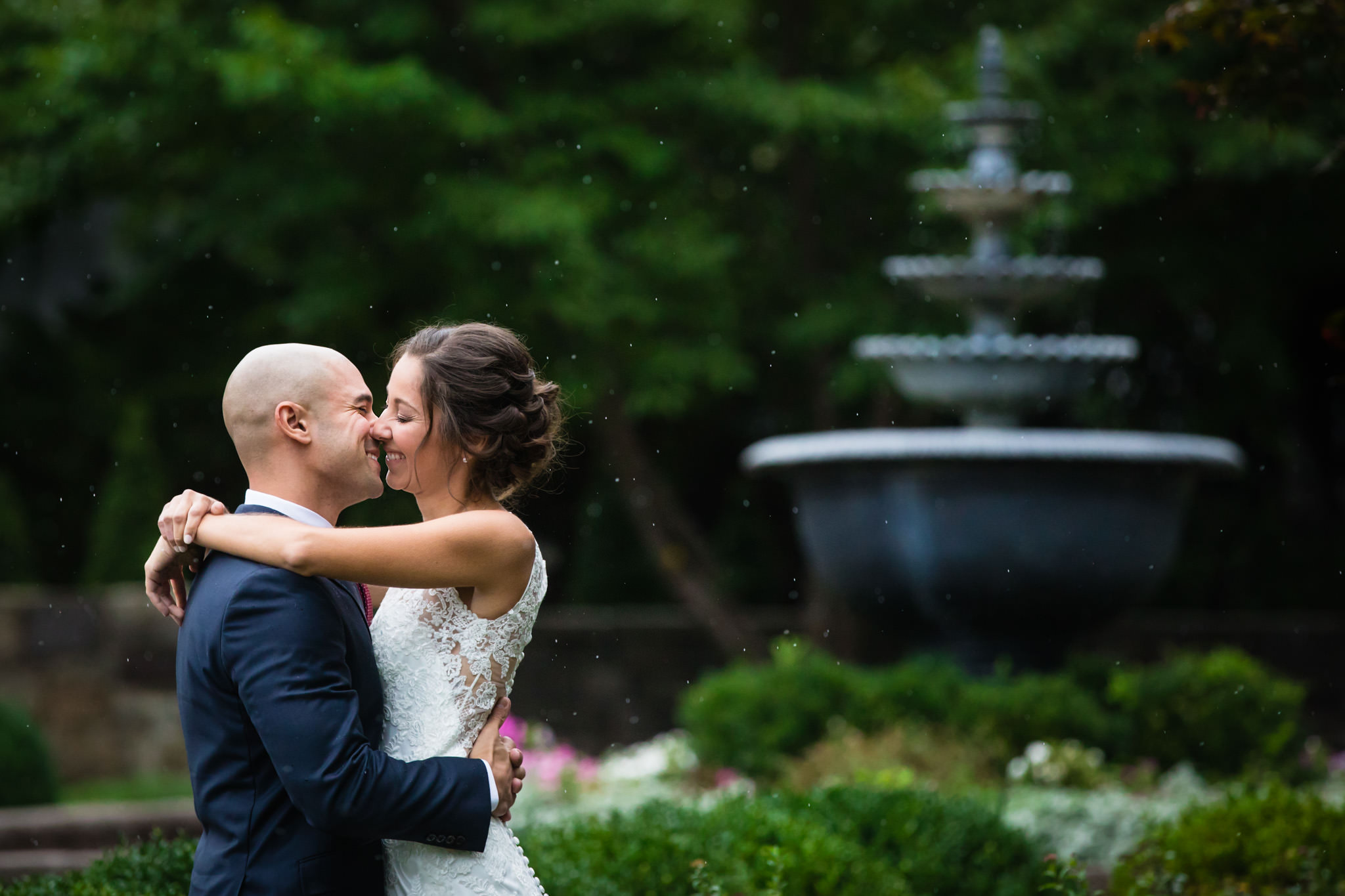 Bride and groom portrait at the fountain at the Farmhouse at the Grand Colonial wedding