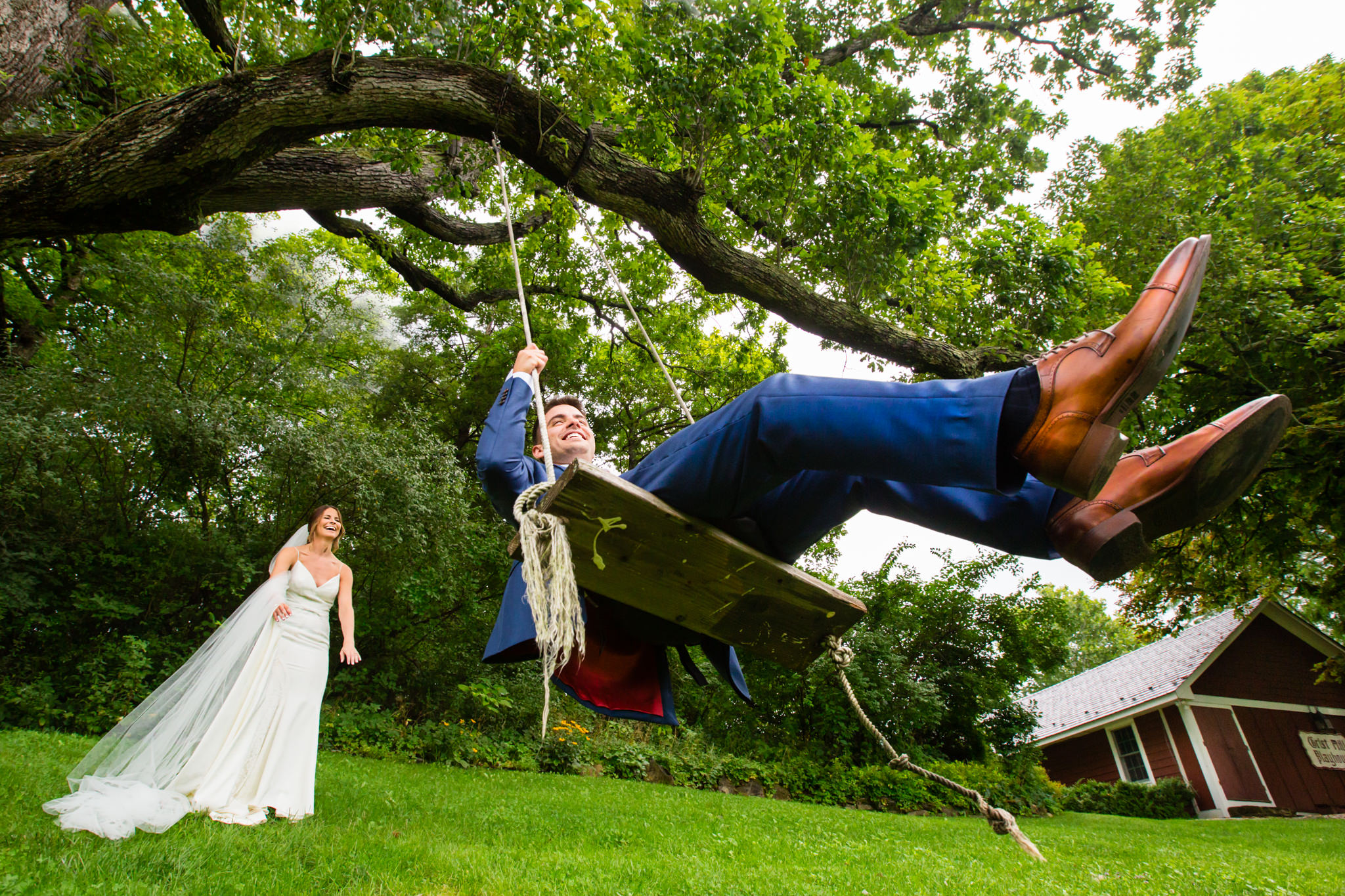 Bride and groom on tree swing at Crossed Keys Estate