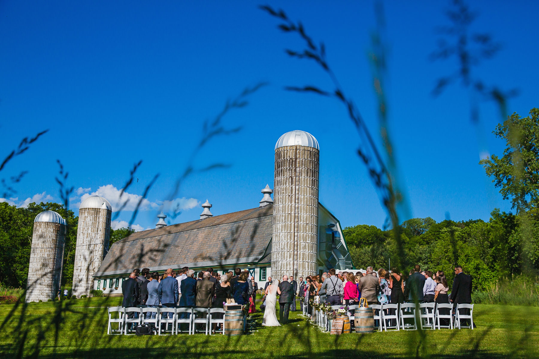 Barn is the backdrop at Perona Farms wedding ceremony