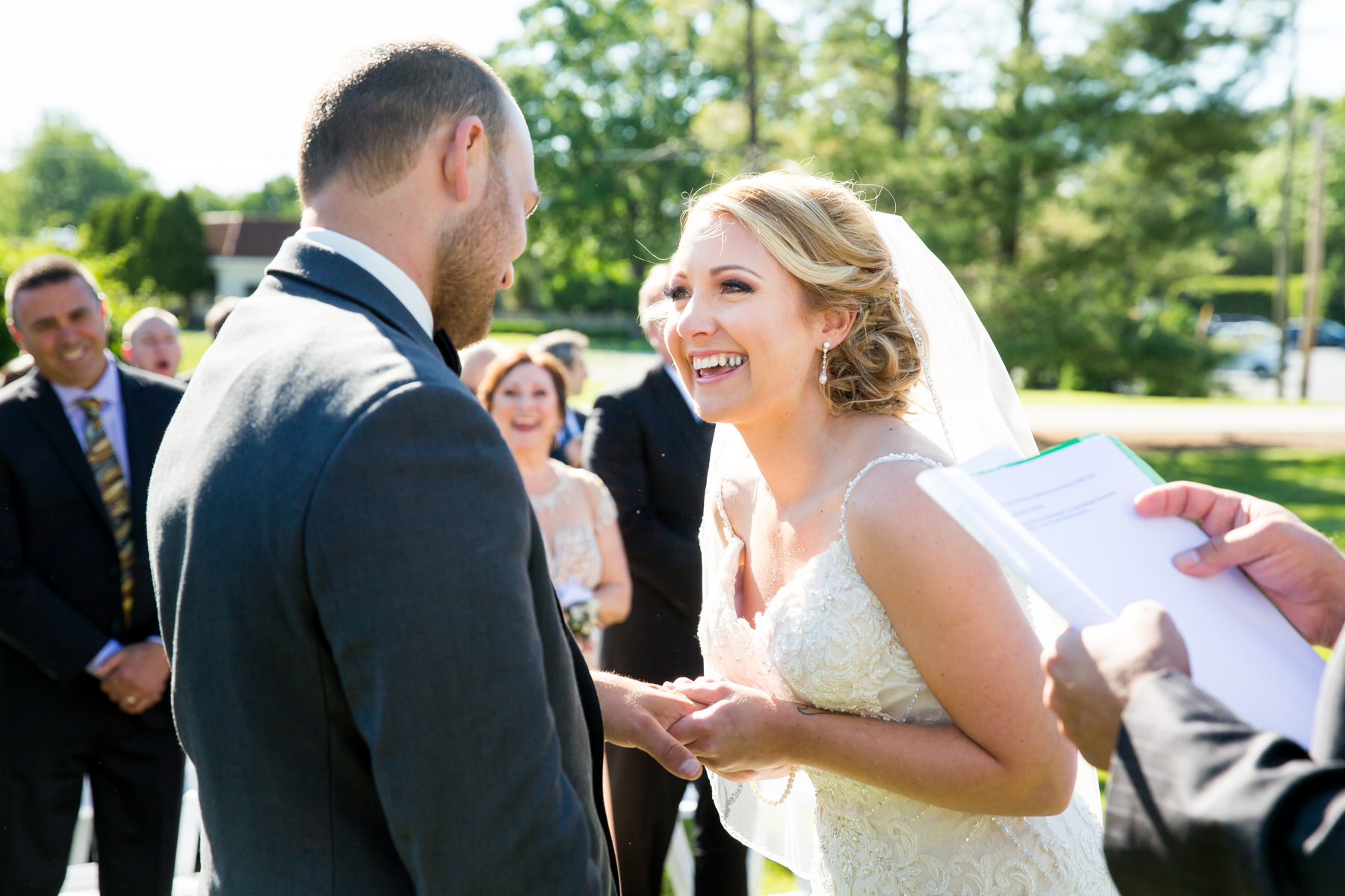 Bride puts ring on groom's finger at wedding at Perona Farms