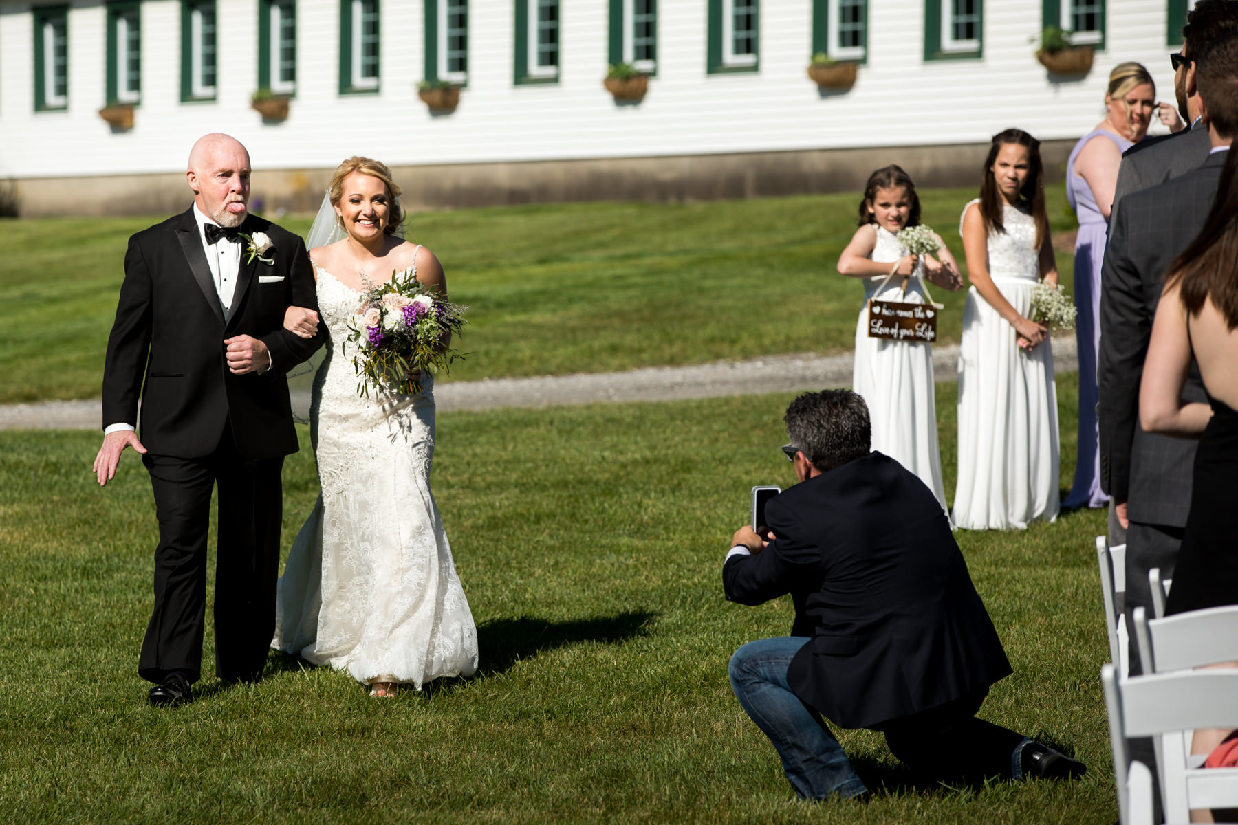 Father of bride walks his daughter down the aisle at outdoor ceremony at Perona Farms wedding