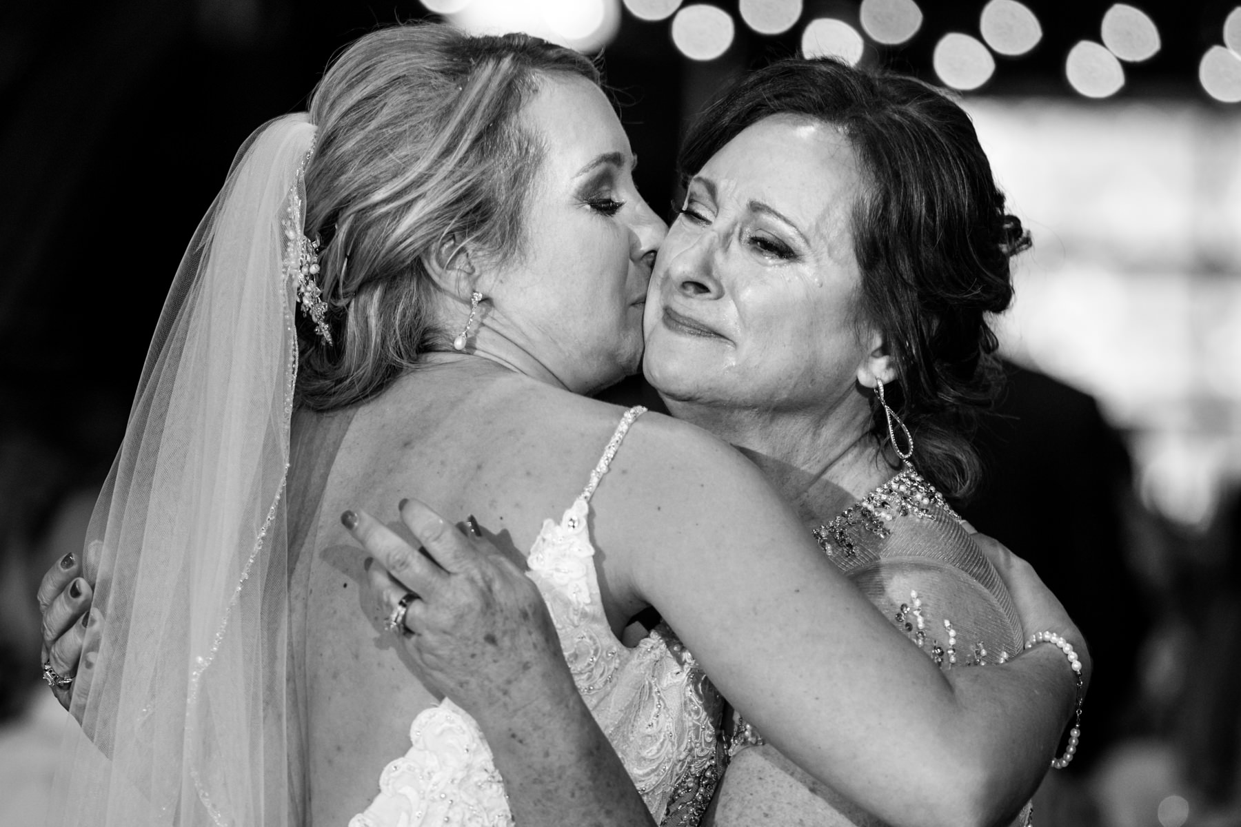 emotional mother of bride hugs her daughter at Perona Farms wedding