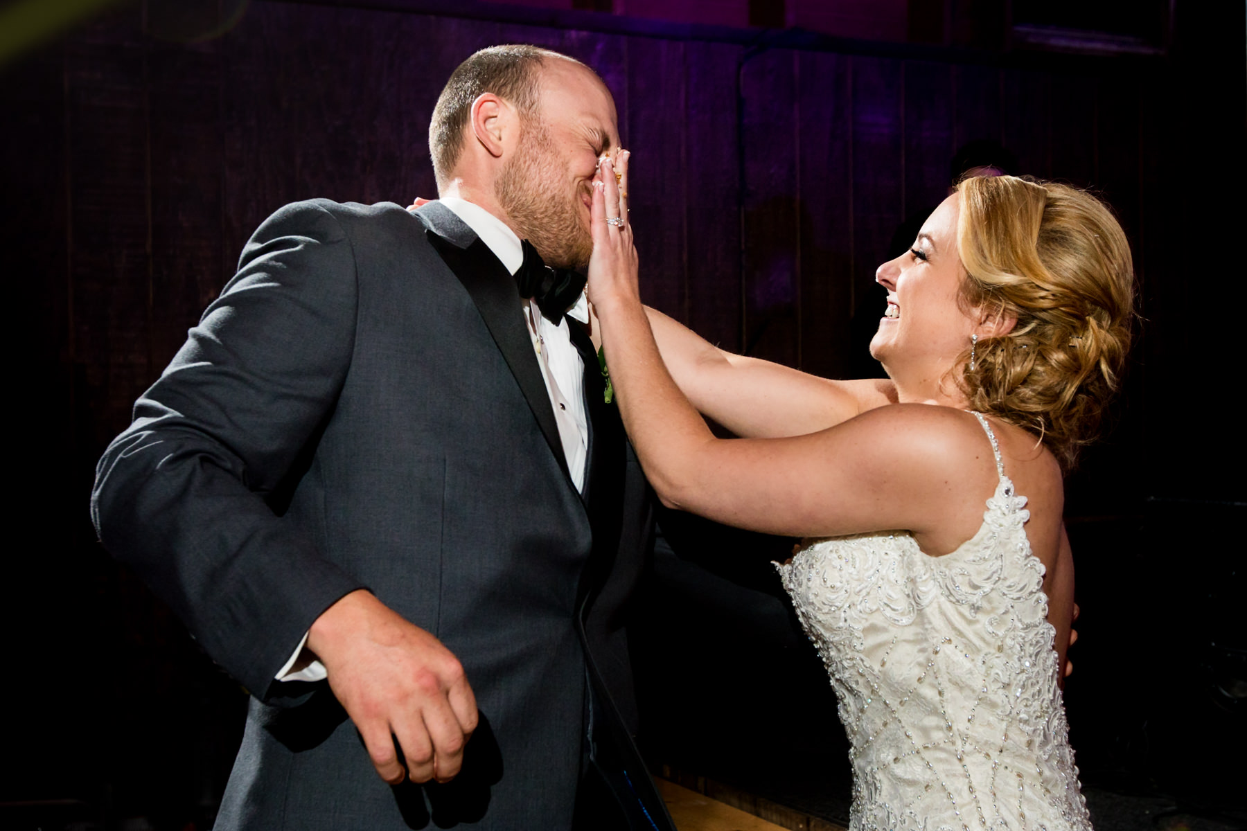 Bride smashes cake in her groom's face at Perona Farms wedding