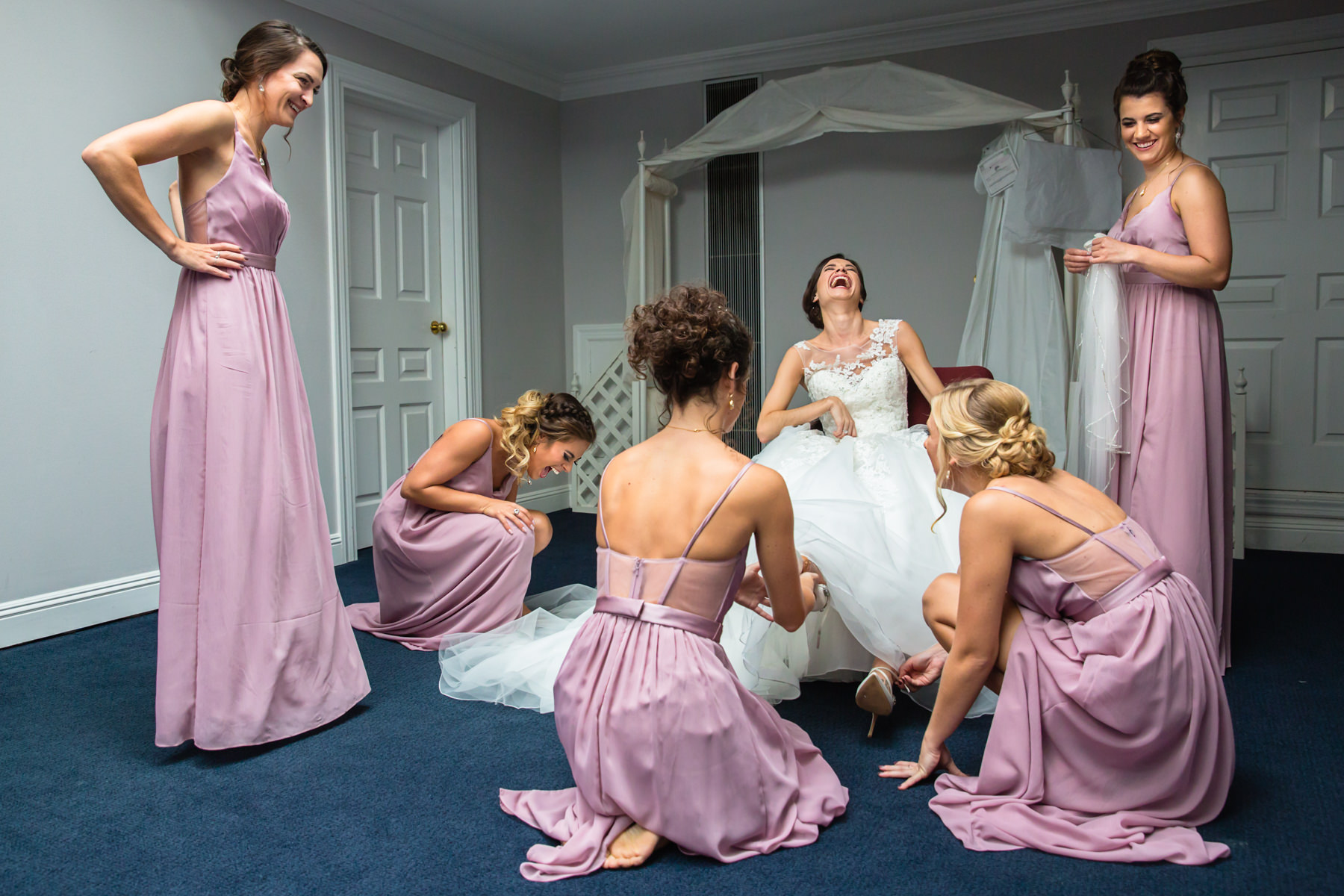 Bridesmaids help bride get ready at Beaver Brook Country Club Wedding