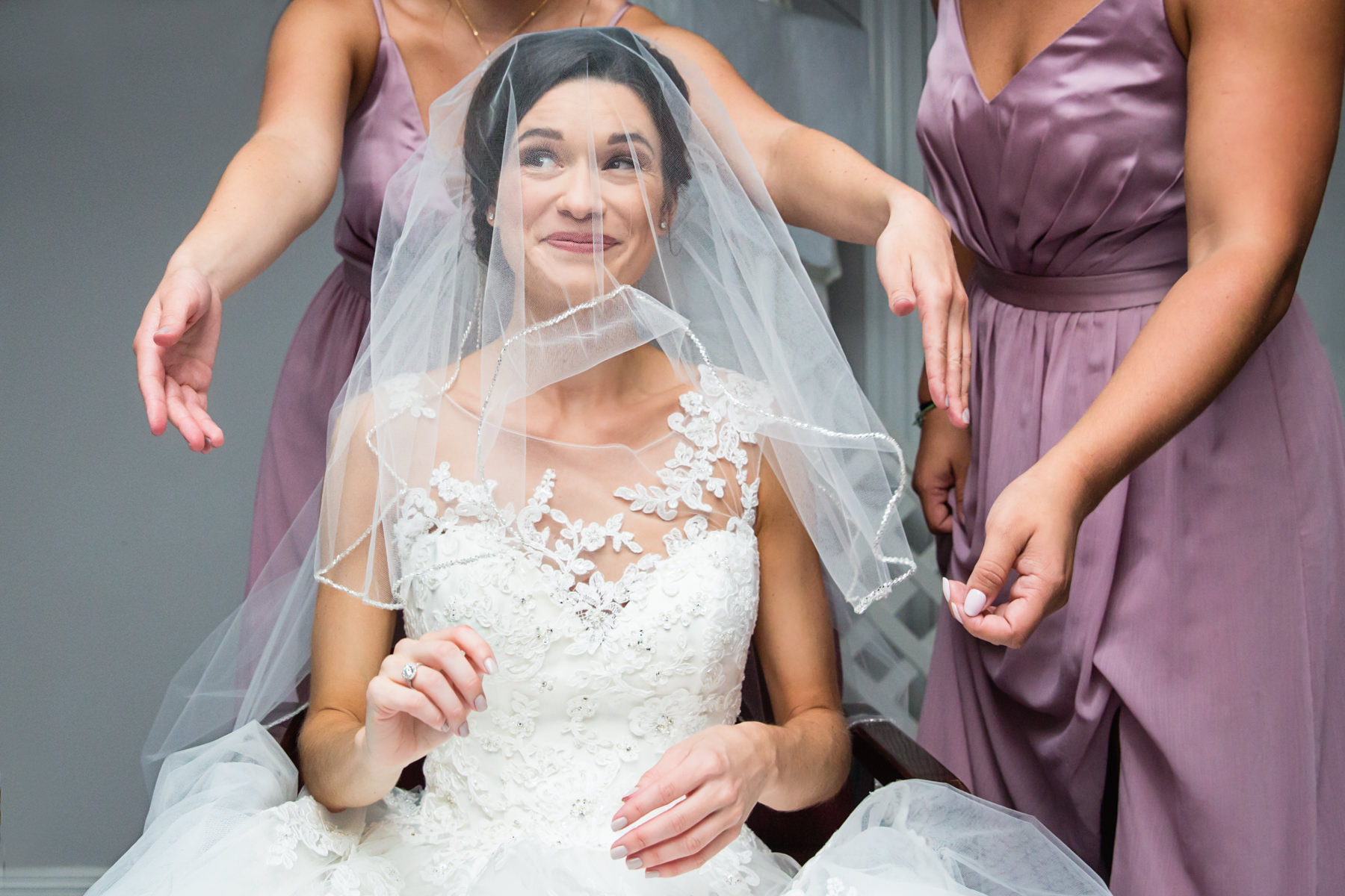 Bridesmaid put veil on bride at Beaver Brook Country Club Wedding