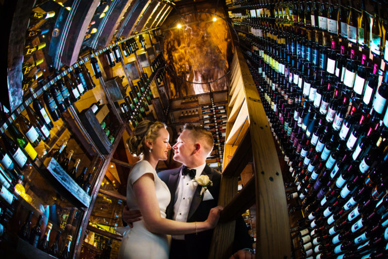 bride and groom in wine room at the Stone House at Stirling Ridge in Warren, NJ