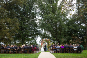 Outdoor lawn wedding ceremony at the Morris Arboretum in Philadelphia, PA