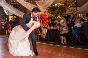Groom dips his new bride during their first dance at the Morris Arboretum in Philadelphia, PA
