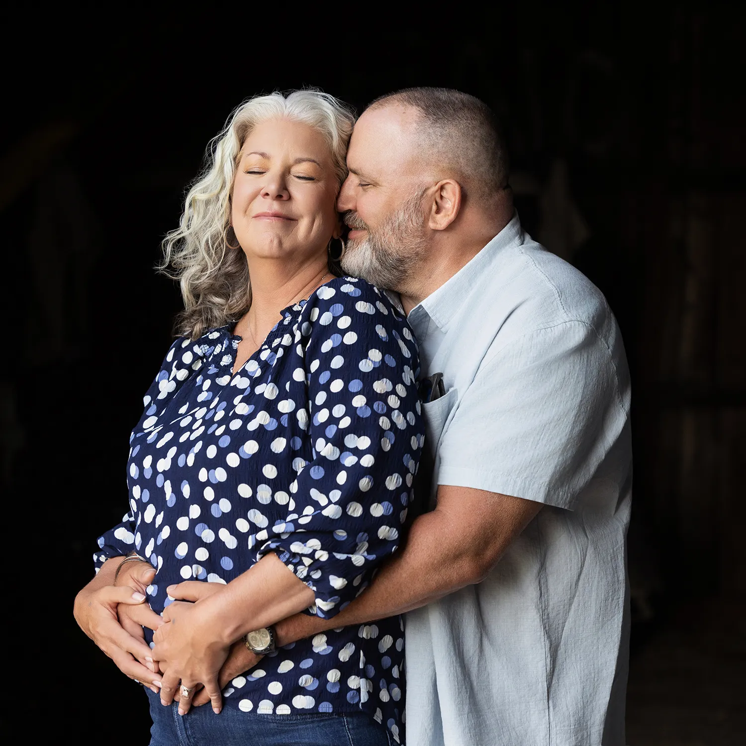 A couple embracing with smiles on their faces