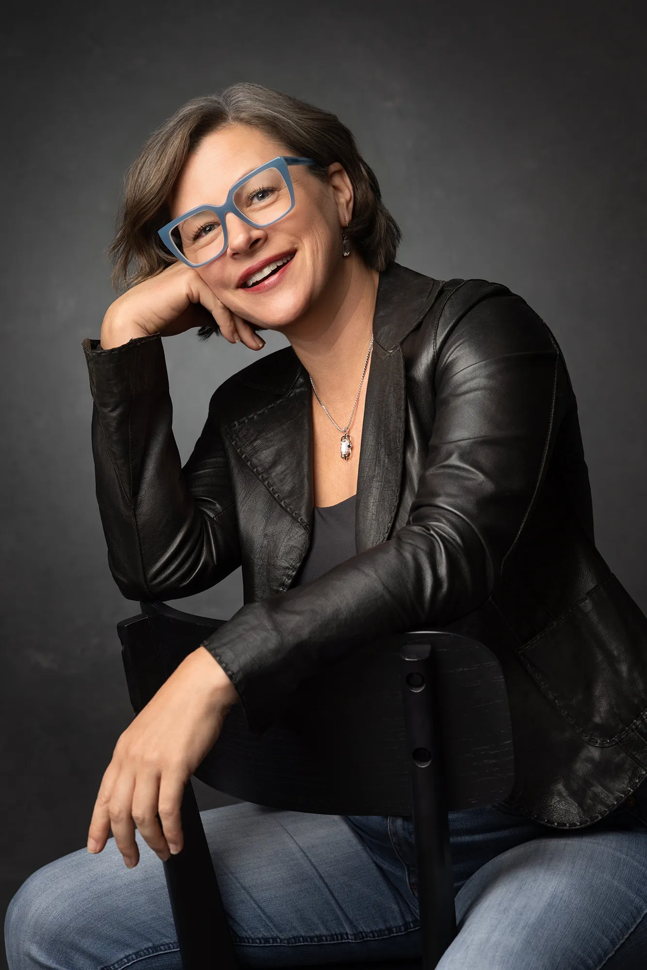 Color portrait of Danette Pascarella smiling in her photography studio